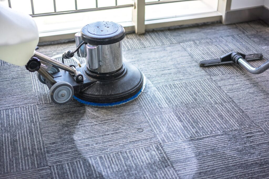 A rotary scrubber machine cleaning commercial carpet tiles by North Seattle Carpet Cleaning in Seattle, WA