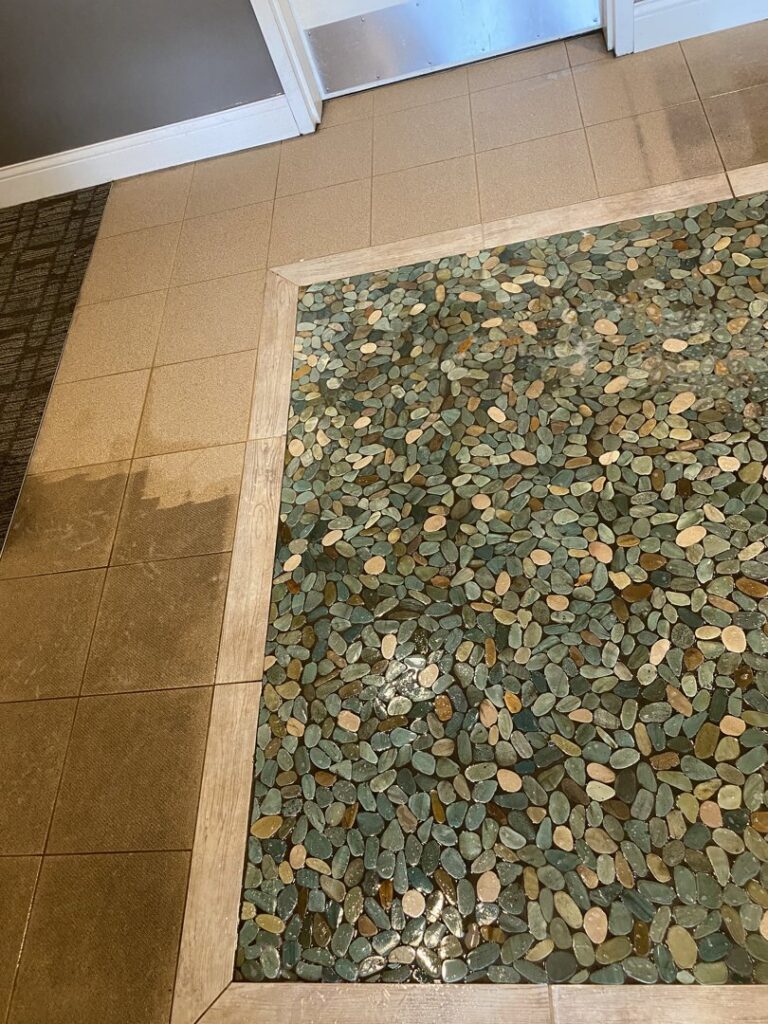 Commercial carpet tiles showing a clear before and after cleaning line by First Response Custom Cleaning in Newport News, VA