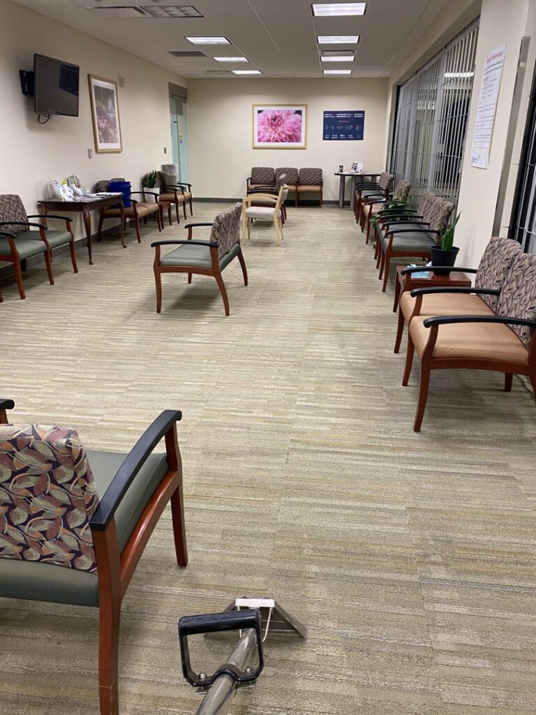 Professional cleaning of patterned carpet tiles in a commercial waiting area by The Floor Care Guys in Bentonville, AR.
