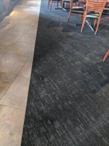 Durable carpet tiles installed in a commercial dining area by Great Spaces Floor Co in Minneapolis, MN.
