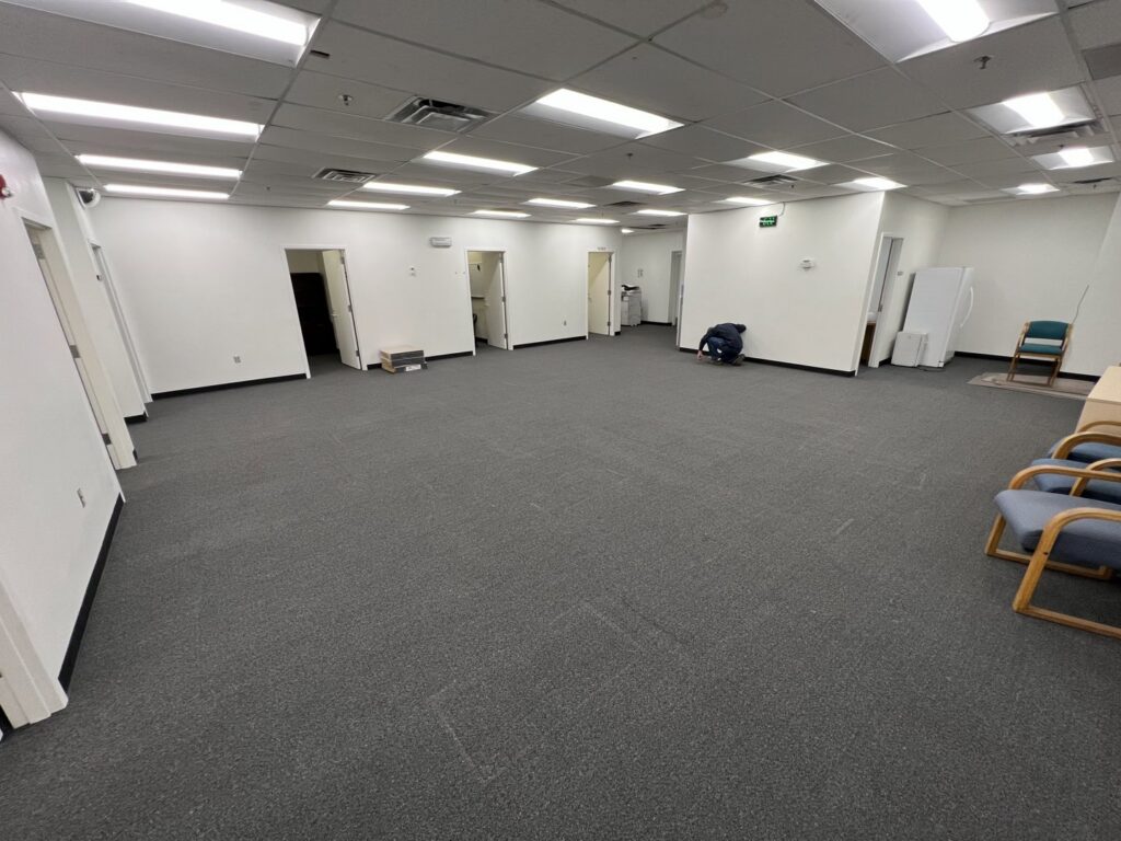 A large commercial office space with newly installed dark grey carpet tiles by Canyon State Flooring in Queen Creek, AZ.