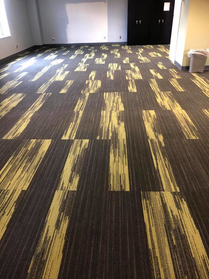 A large commercial room with newly installed patterned carpet tiles by Conaway Flooring LLC in Wheeling, WV.