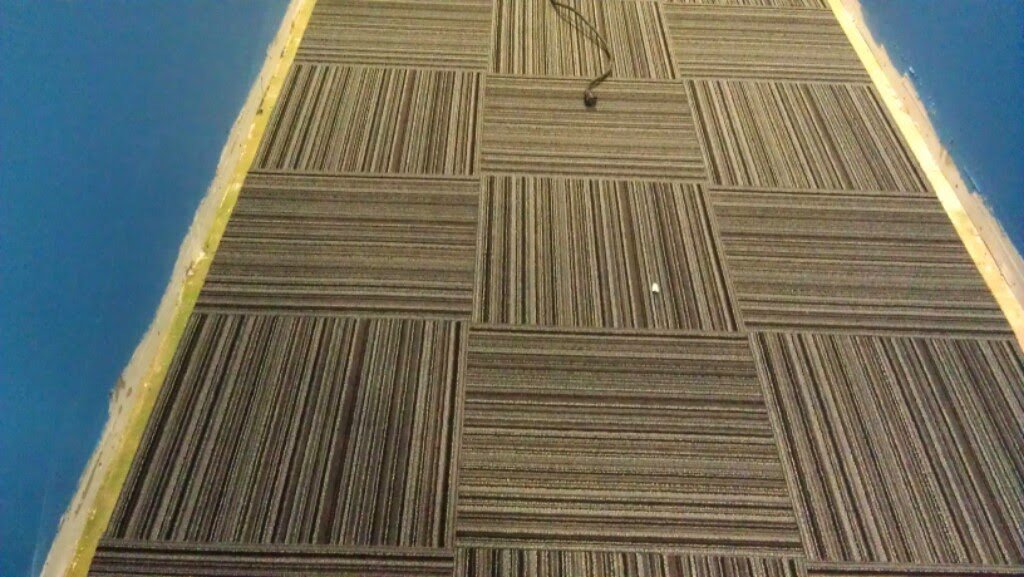 Commercial carpet tiles with a striped pattern expertly installed by Delgado Carpet Services in San Jose, CA