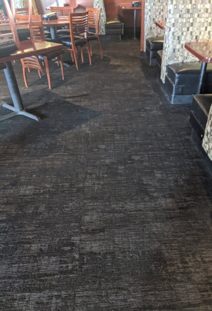 Newly installed dark patterned carpet tiles in a commercial hallway by Great Spaces Floor Co in Minneapolis, MN.