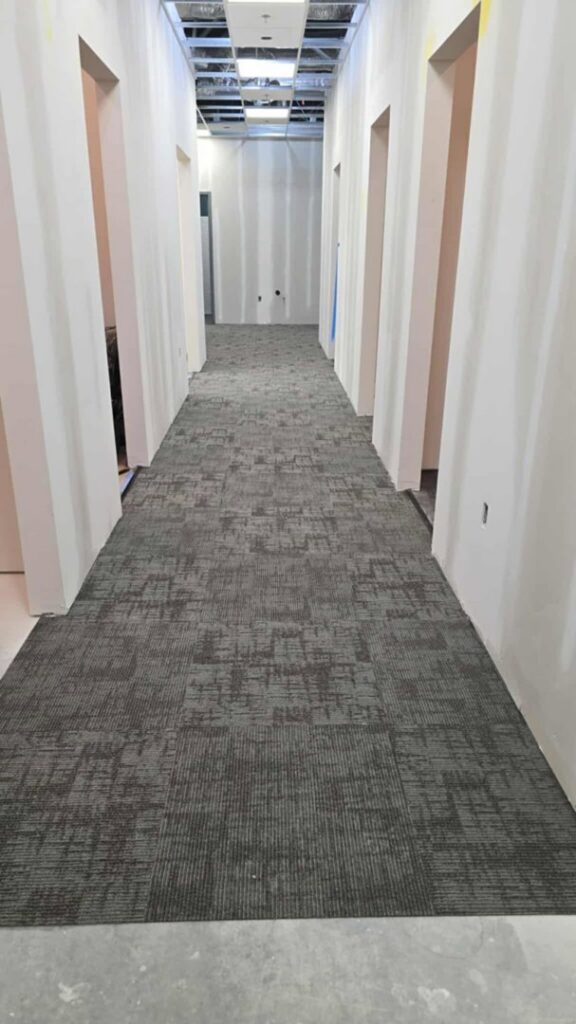 Installation of commercial carpet tiles in a hallway by Johnson City Flooring & Finish, LLC in Johnson City, TN