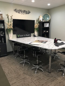 A modern office conference room featuring patterned carpet tile installation by InVision Construction in Pearl, MS.