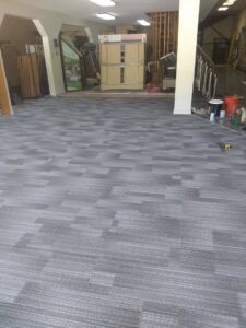 Extensive grey patterned carpet tile installation in a large commercial area by Carpet Center in Wilmington, NC.