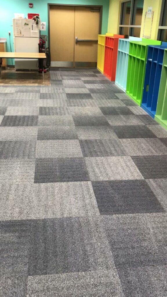 Clean commercial carpet tiles in a hallway, showcasing the type of flooring Elementscarpetcleaning.net works with in Omaha, NE.
