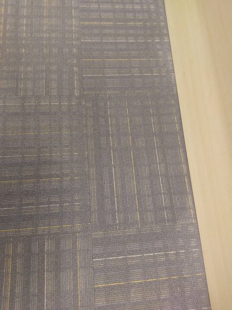 Close-up of clean, patterned commercial carpet tiles, showcasing quality work by Real Green Cleaning in Indianapolis, IN.