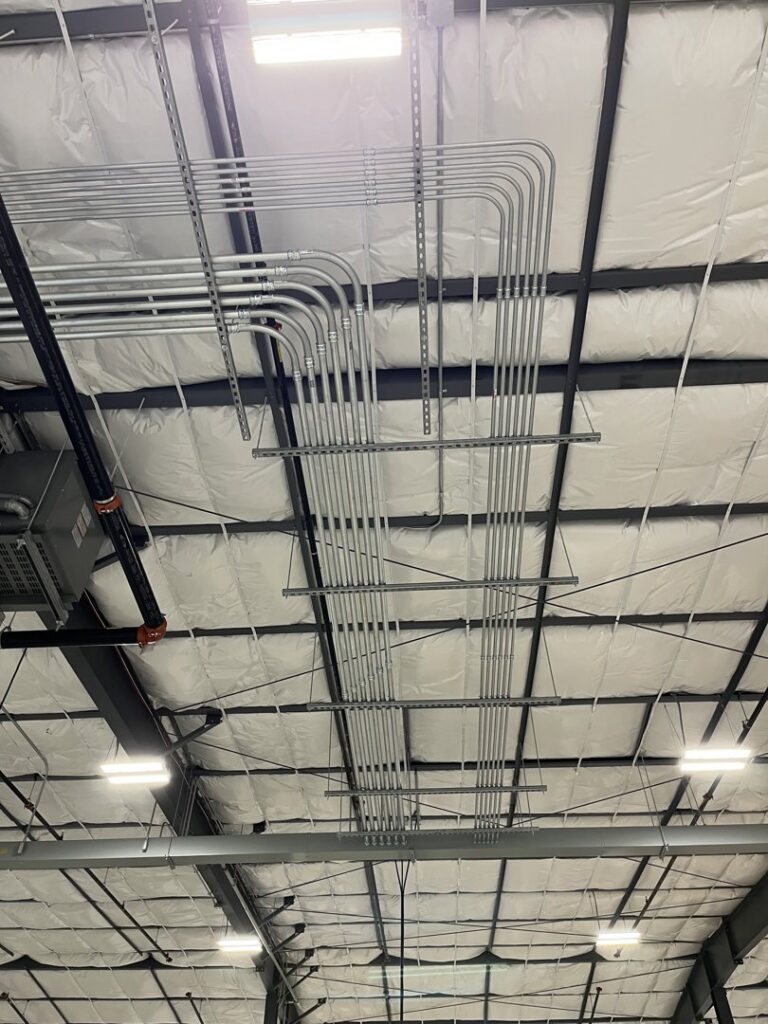 Commercial ceiling with extensive electrical conduit and lighting fixtures installed by Patriot Electric L.L.C in Phoenix, AZ