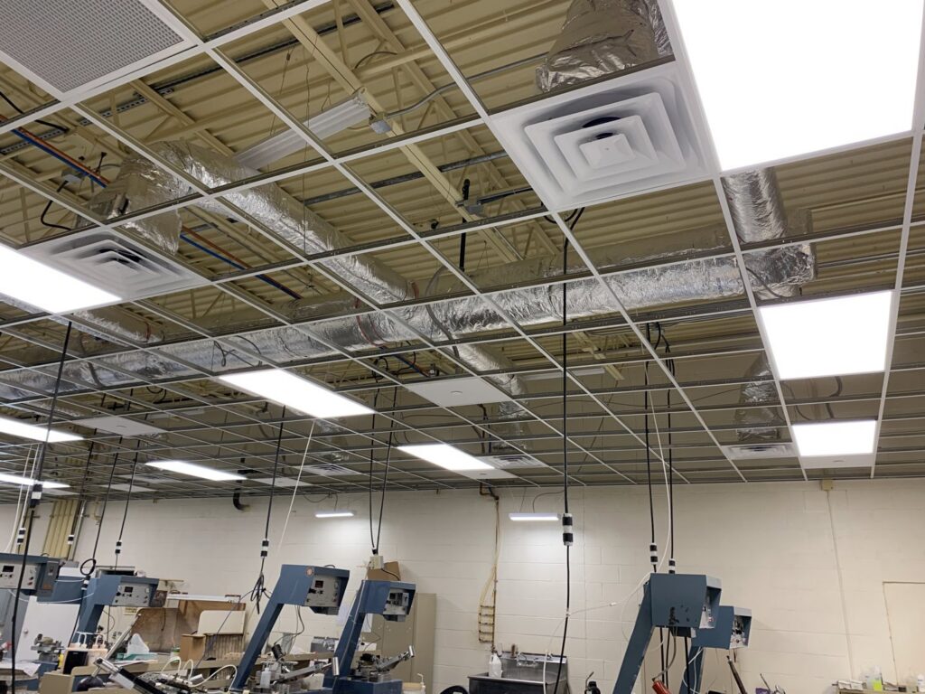 Commercial ceiling showing installed ductwork and air diffusers by Elite Mechanical in Manchester, NH.