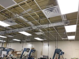 Commercial ceiling showing installed ductwork and air diffusers by Elite Mechanical in Manchester, NH.