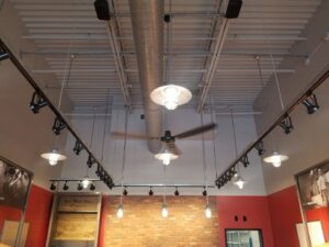Commercial ceiling with modern track lighting and pendant fixtures installed by Electrifying Services in Indianapolis, IN