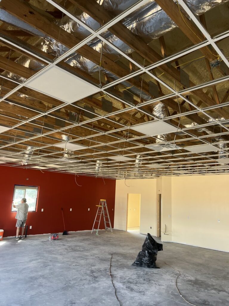 Commercial space showing electrical wiring and a drop ceiling grid installation by Ace Electrical Services LLC in Owensboro, KY.