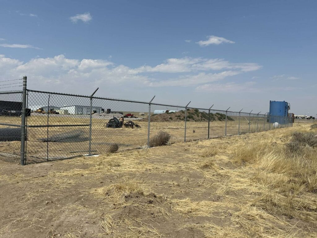 Commercial chain link fence with barbed wire installed by Cowboy State Fencing LLC in Riverton, WY.