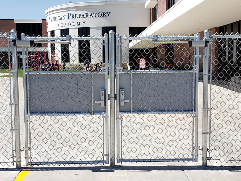 Commercial chain-link fence gates providing security for a school building installed by Allied Fence Co in Tulsa, OK.