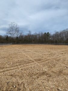 Commercial chain link fence surrounding a large gravel lot installed by National Fence and Gate in Ironton, MO.