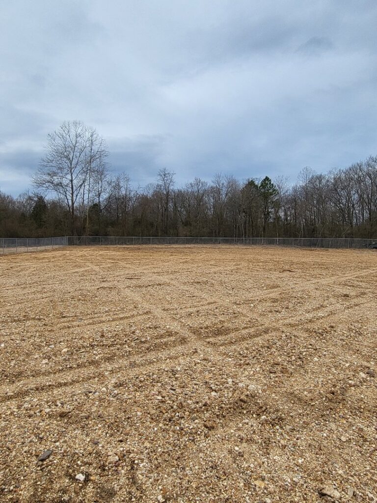 Commercial chain link fence surrounding a large gravel lot installed by National Fence and Gate in Ironton, MO.