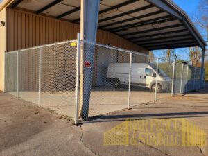 A commercial chain-link fence installation by R&R Fence & Stain LLC in Madison, AL, enclosing a property.