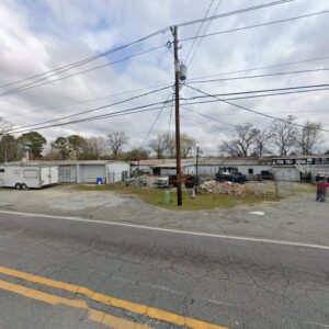 A commercial property secured with a chain-link fence, demonstrating fencing services by G2 Home Solutions in Phenix City, AL.