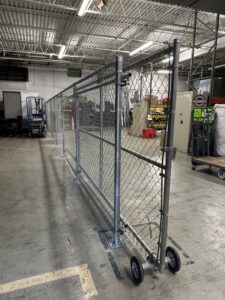A commercial chain link fence installed inside a warehouse or industrial facility by Limitless Boundaries LLC in Garner, NC.