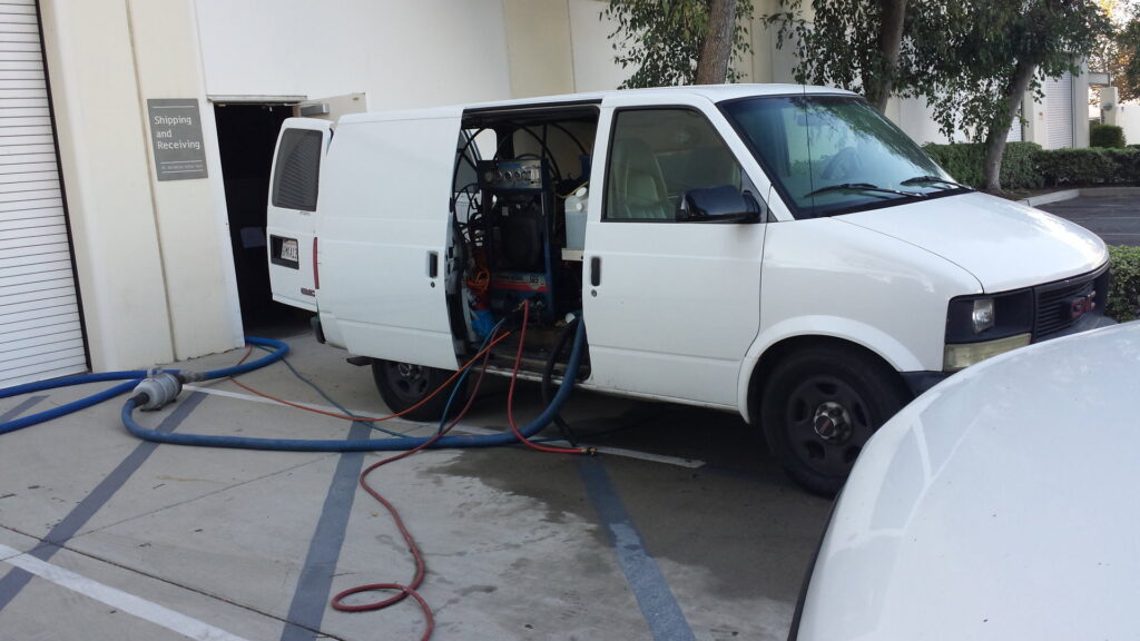A Harper's Cleaning Services van with equipment for a commercial carpet cleaning job in Anaheim, CA.