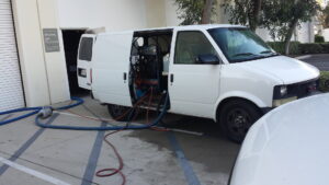 A Harper's Cleaning Services van with equipment for a commercial carpet cleaning job in Anaheim, CA.