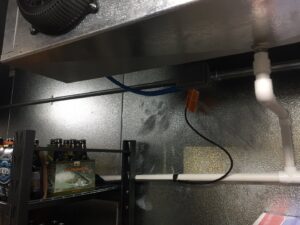 Electrical conduit and wiring installed in a commercial cooler or storage area, demonstrating commercial electrical services by GOBE LLC in Columbia, MO.