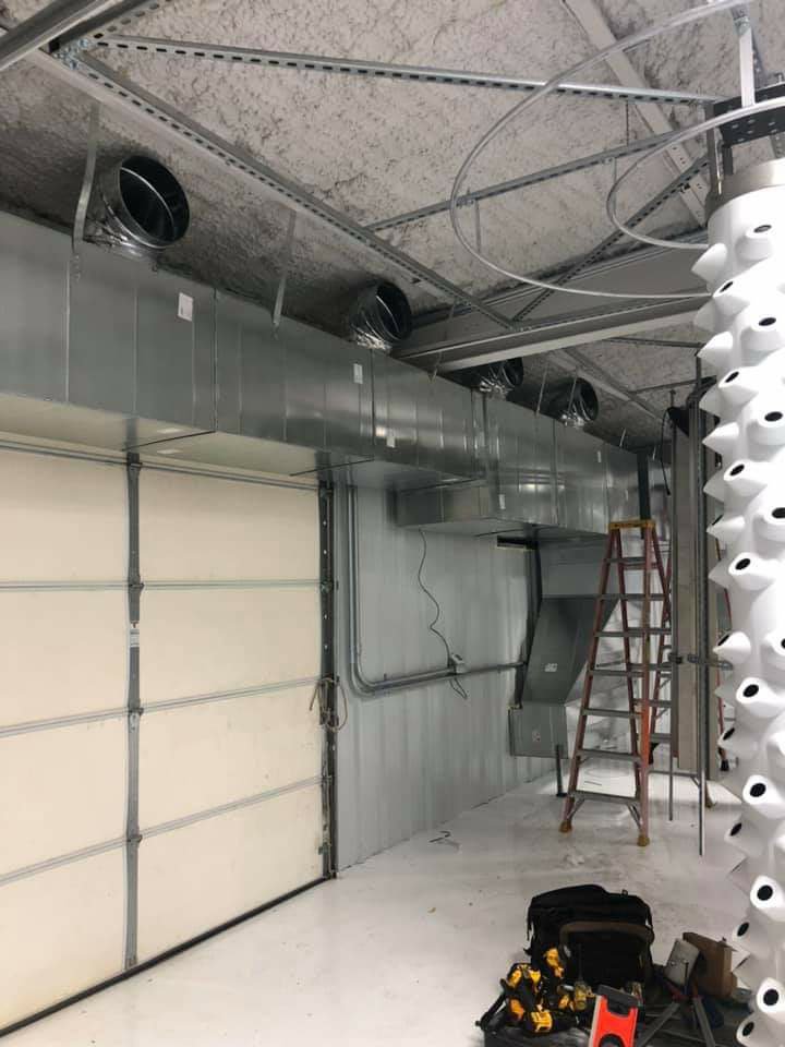 Commercial ductwork installation in a large indoor space by Griffin's Heating & Air in Tulsa, OK.