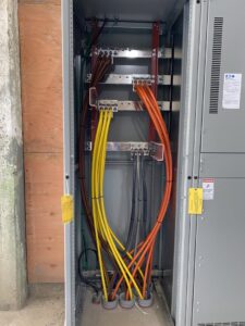 Interior of a commercial electrical cabinet showing heavy gauge wiring and busbars by Patriot Electric L.L.C in Phoenix, AZ