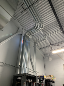 Commercial electrical conduit installation on a ceiling by Alyeska Electric in Anchorage, AK, showing neat pipe runs.
