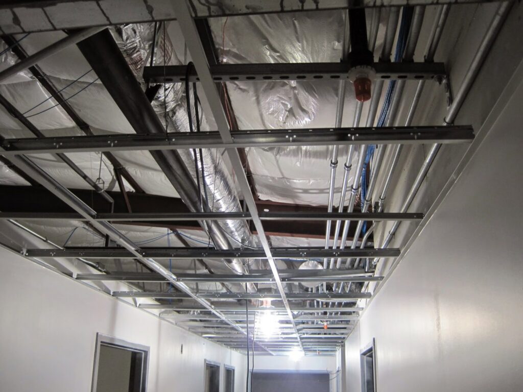 Exposed electrical conduits and wiring installed in a commercial building ceiling by Argosy Electric, Inc. in Newport News, VA