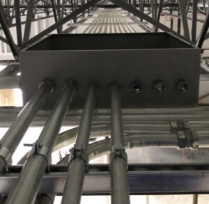 Electrical conduits and junction boxes installed along a ceiling structure in a commercial building by Lighten Up Electric, LLC in Cranston, RI.