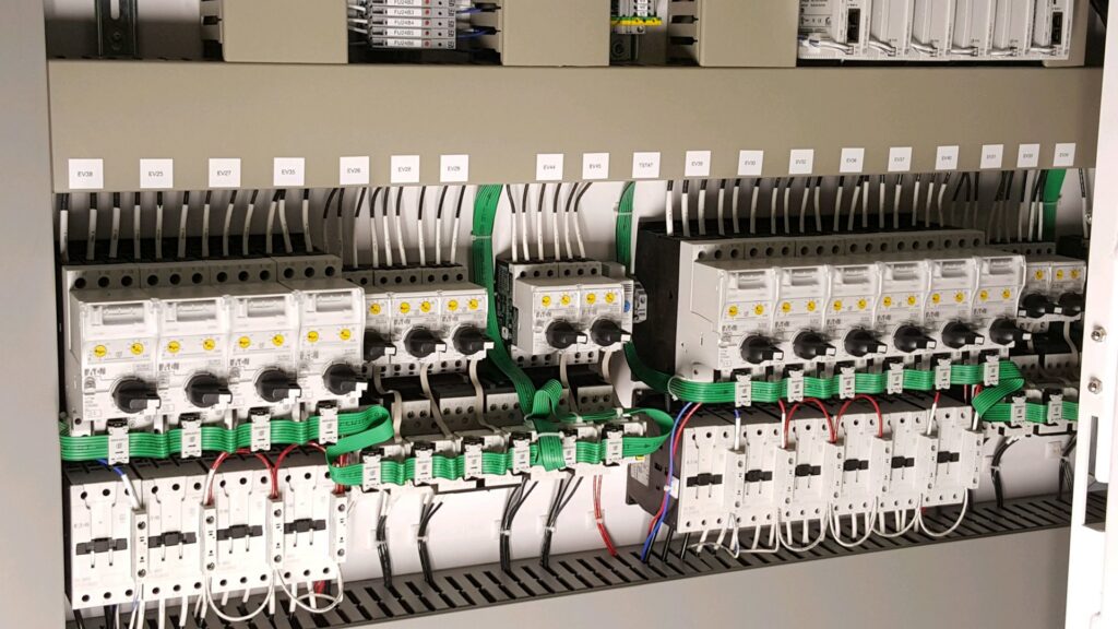 A detailed view of a commercial electrical control panel with organized wiring by Progressive Electrical Services, Inc. Lee, NH.