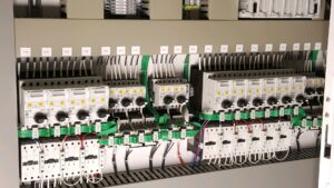 A detailed view of a commercial electrical control panel with organized wiring by Progressive Electrical Services, Inc. Lee, NH.