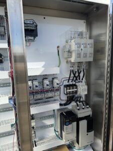Inside a commercial electrical control panel with complex wiring and components, serviced by MCM Electrical Services LLC in Phoenix, AZ