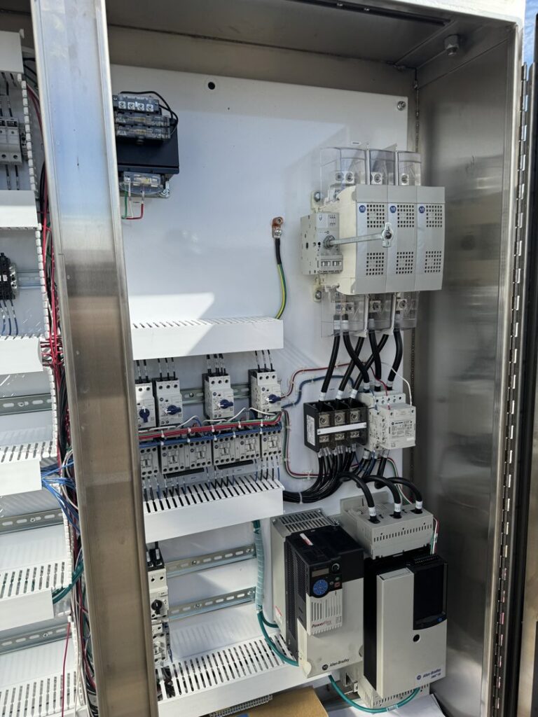 Inside a commercial electrical control panel with complex wiring and components, serviced by MCM Electrical Services LLC in Phoenix, AZ