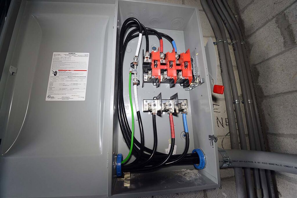 A commercial electrical disconnect box with heavy wiring by T-Volt, Inc. Electrical Contractor in Fort Lauderdale, FL.