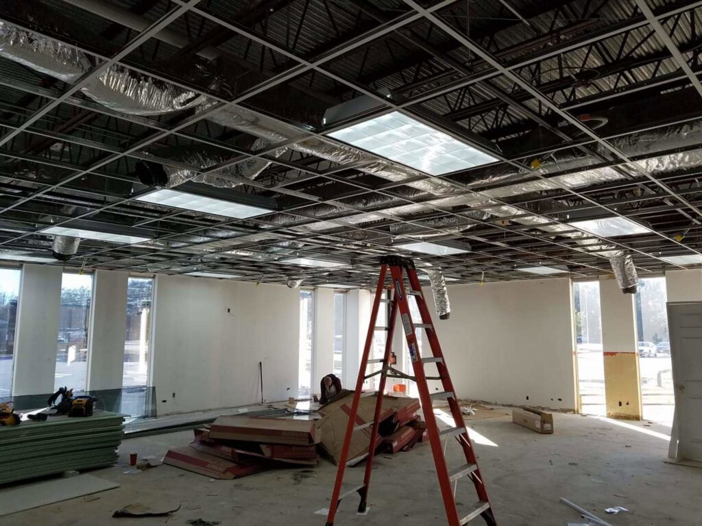 Commercial electrical installation in progress, showing ceiling grid and light fixtures by Shark Electric in Houston, TX.