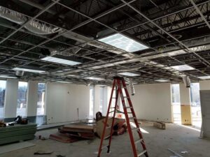 Commercial electrical installation in progress, showing ceiling grid and light fixtures by Shark Electric in Houston, TX.