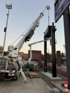 R&R Electric, Inc. performing commercial electrical installation with a crane truck in Florissant, MO.
