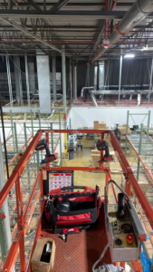 An electrician's view from a scissor lift during a commercial electrical installation project by FRK_Electrical_Contractors in Chicago, IL