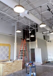Commercial electrical and lighting installation in progress with exposed wiring and fixtures by Genesys Electrical Contractors in Dallas, TX