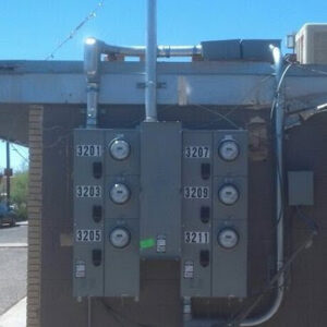A bank of multiple commercial electrical meter panels installed on a building exterior by Certified Electrician Albuquerque NM.