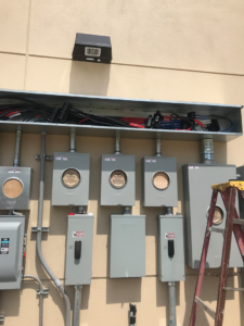 Multiple commercial electrical meters and conduits installed on a building wall by All City Electrical in Orlando, FL