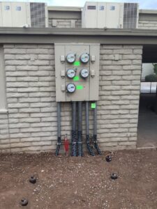 Commercial electrical meter and conduit installation on a brick building by EV Electric LLC in Mesa, AZ
