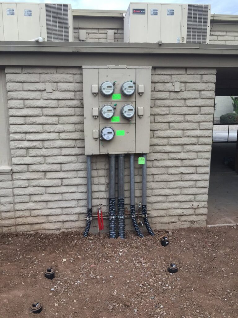 Commercial electrical meter and conduit installation on a brick building by EV Electric LLC in Mesa, AZ