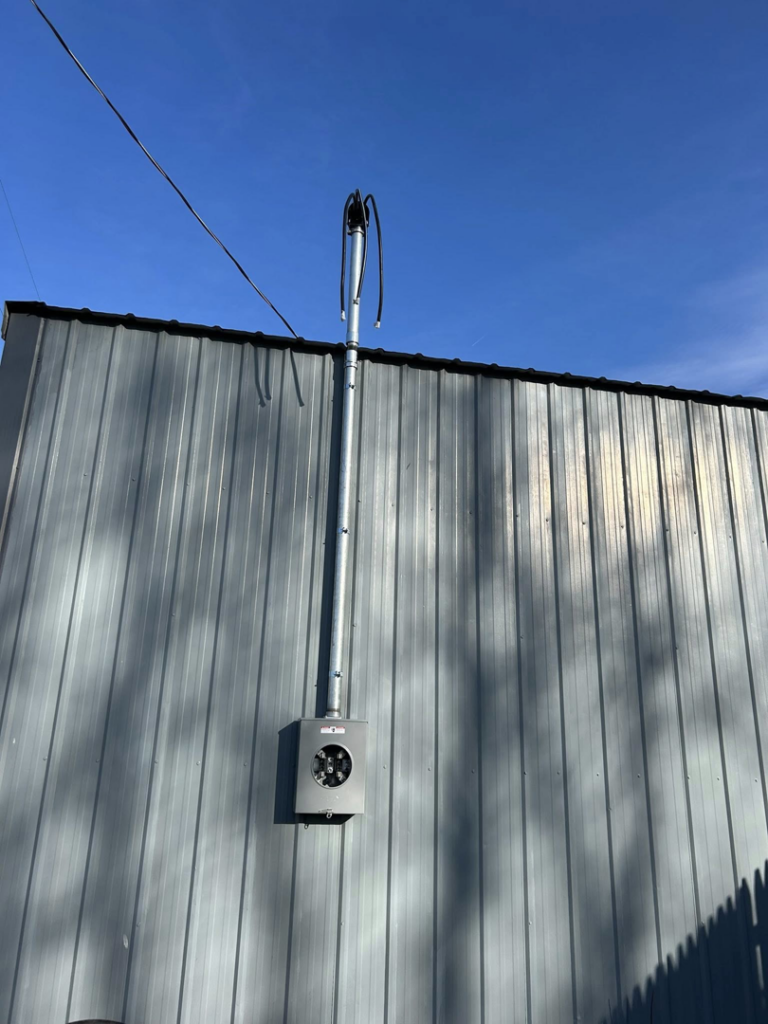A commercial electrical meter and conduit installation on a building by Heritage Electric LLC in Indianapolis, IN.