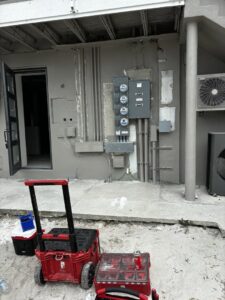 Multiple electrical meters and conduits installed on an exterior wall by Phoenix Electric, Inc. in Cape Coral, FL