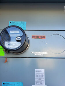 A commercial electrical meter and panel with voltage labels, serviced by TJS Electrical Services Inc in Mesa, AZ.